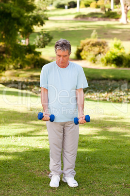 Mature man doing his exercises in the park