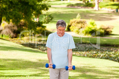 Mature man doing his exercises in the park