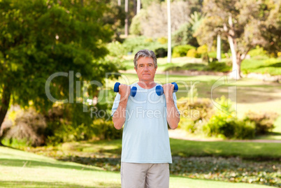 Mature man doing his exercises in the park