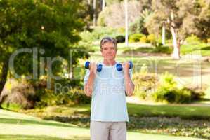 Mature man doing his exercises in the park