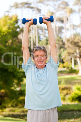 Mature man doing his exercises in the park