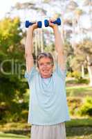 Mature man doing his exercises in the park