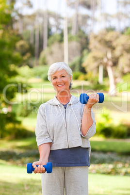 Mature woman doing her exercises in the park