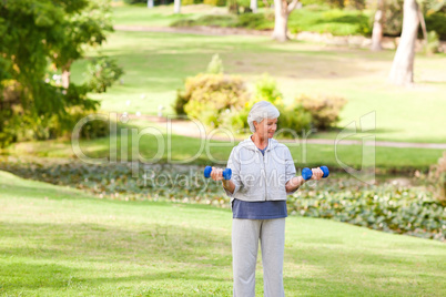 Mature woman doing her exercises in the park