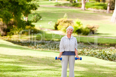 Mature woman doing her exercises in the park