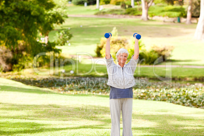 Mature woman doing her exercises in the park