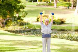 Mature woman doing her exercises in the park