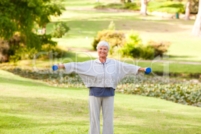 Mature woman doing her exercises in the park