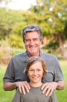 Grandfather with his grandson in the park