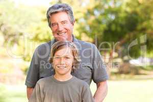 Grandfather with his grandson in the park