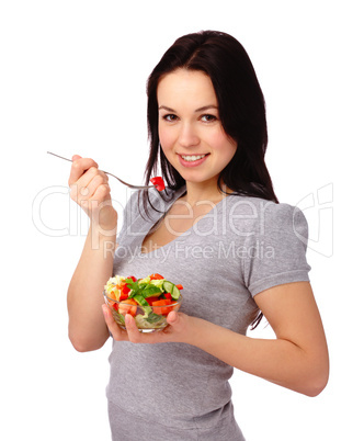 Young attractive woman eats vegetable salad