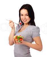 Young attractive woman eats vegetable salad