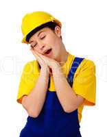 Young woman in construction uniform is yawning