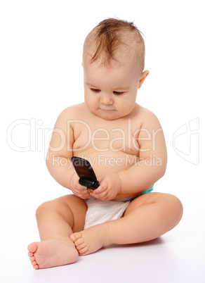 Cute little baby plays with mobile phone