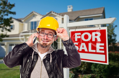 Contractor in Hard Hat in Front of House and Sign