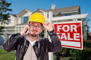 Contractor in Hard Hat in Front of House and Sign