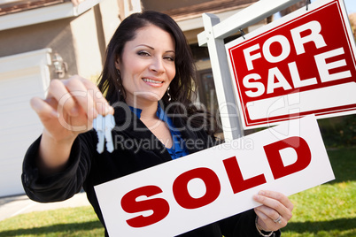 Hispanic Woman Holding Sold Real Estate Sign and Keys in Front H