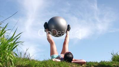 Young woman exercising with ball