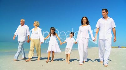 Three Generations of Family Walking on the Beach