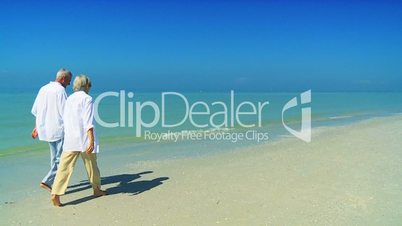 Retired Couple Barefoot on the Beach