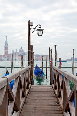 Gondola at the end of the bridge with blue cover