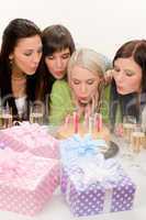 Birthday party - woman blowing candle on cake