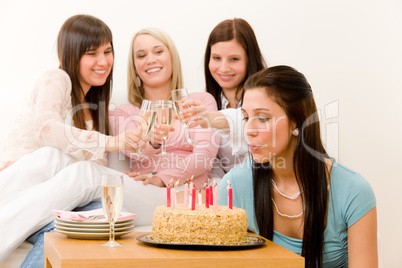 Birthday party - woman blowing candle on cake