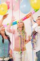 Birthday party celebration - four woman with confetti