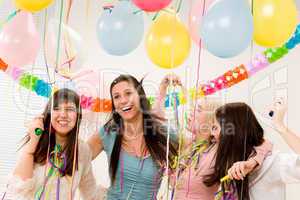 Birthday party celebration - four woman with confetti have fun