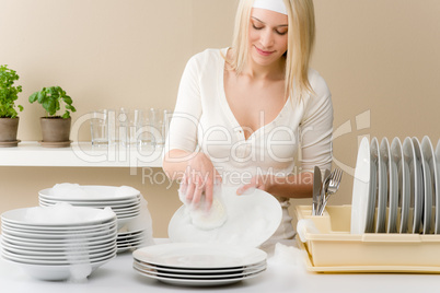 Modern kitchen - happy woman washing dishes