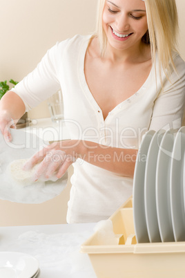 Modern kitchen - happy woman washing dishes