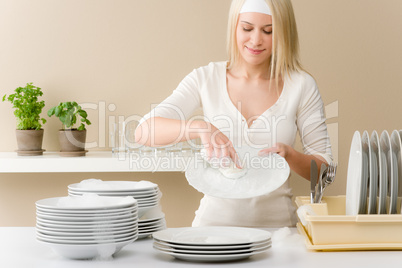 Modern kitchen - happy woman washing dishes