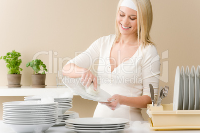 Modern kitchen - happy woman washing dishes