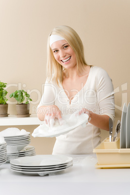 Modern kitchen - happy woman washing dishes