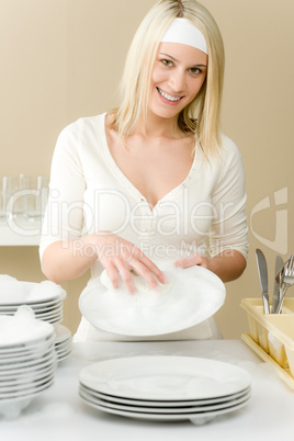 Modern kitchen - happy woman washing dishes