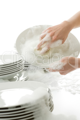 Washing dishes - hands with gloves in kitchen