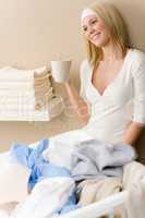 Laundry ironing - woman break with drink