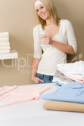Laundry ironing - woman break with drink