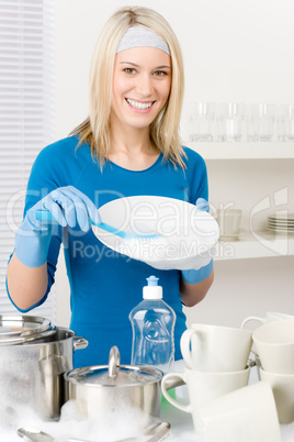 Modern kitchen - happy woman washing dishes