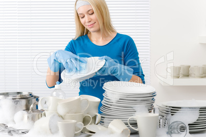 Modern kitchen - happy woman washing dishes