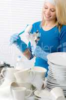 Modern kitchen - happy woman washing dishes