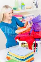 Laundry - woman folding clothes home