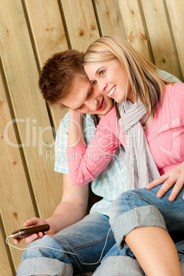 Couple in love - summer fun on beach with music