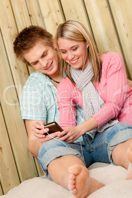 Couple in love - summer fun on beach with music