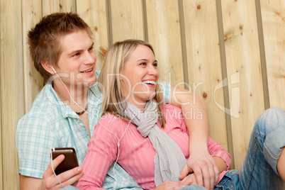 Couple in love - summer fun on beach with music