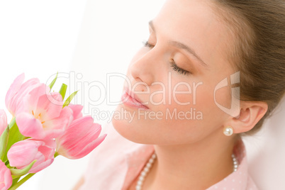Fashion - young romantic woman smell spring tulips