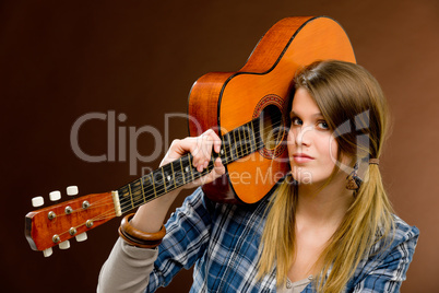 Rock musician - fashion woman holding guitar