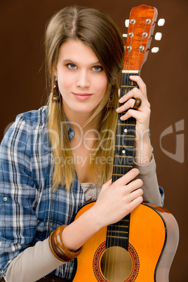 Rock musician - fashion woman holding guitar