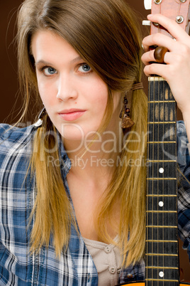 Rock musician - fashion woman holding guitar