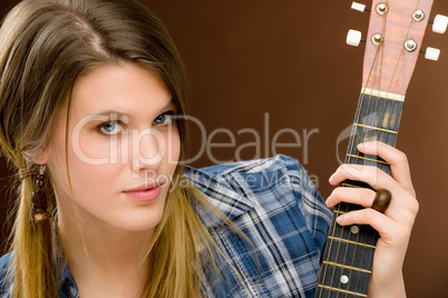 Rock musician - fashion woman holding guitar